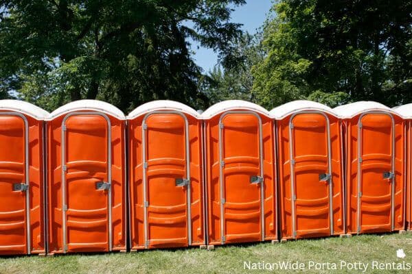 a lineup of clean and well-maintained portable loos for workers in Santa Fe, NM